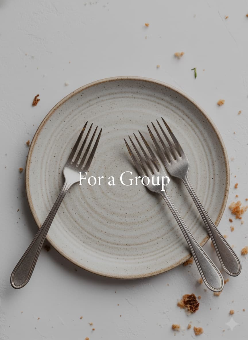 Two forks on ceramic plate representing group cookbook creation