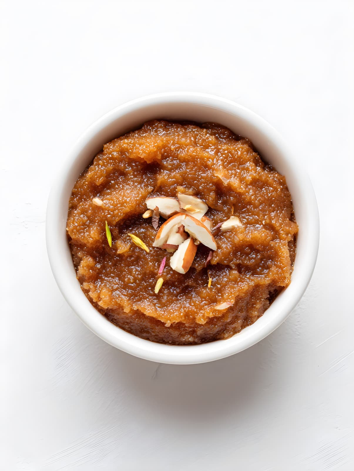 Halwa with almonds in a white bowl, recreated by the studio