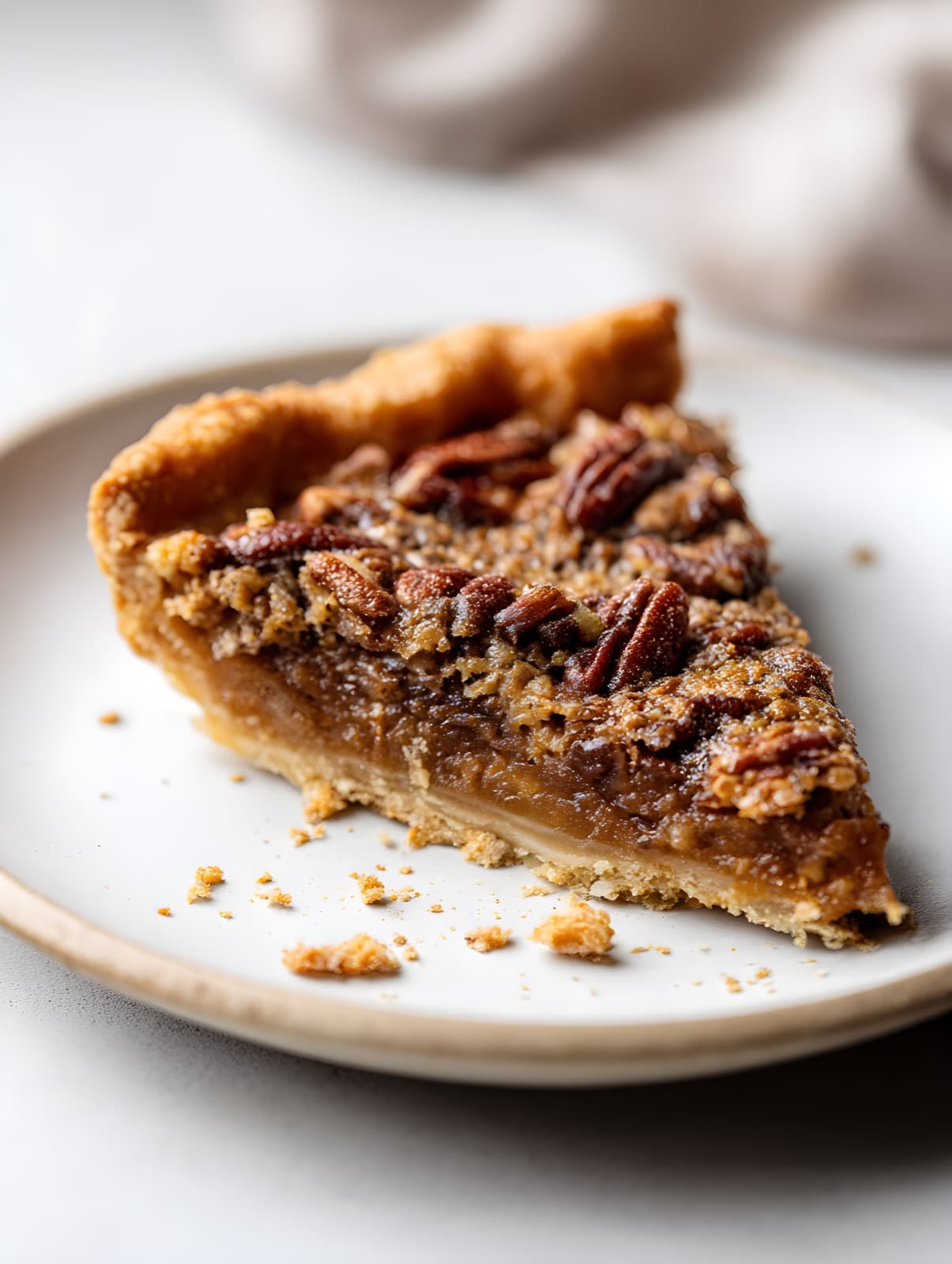A slice of pecan pie with whole pecans on top, recreated by the studio