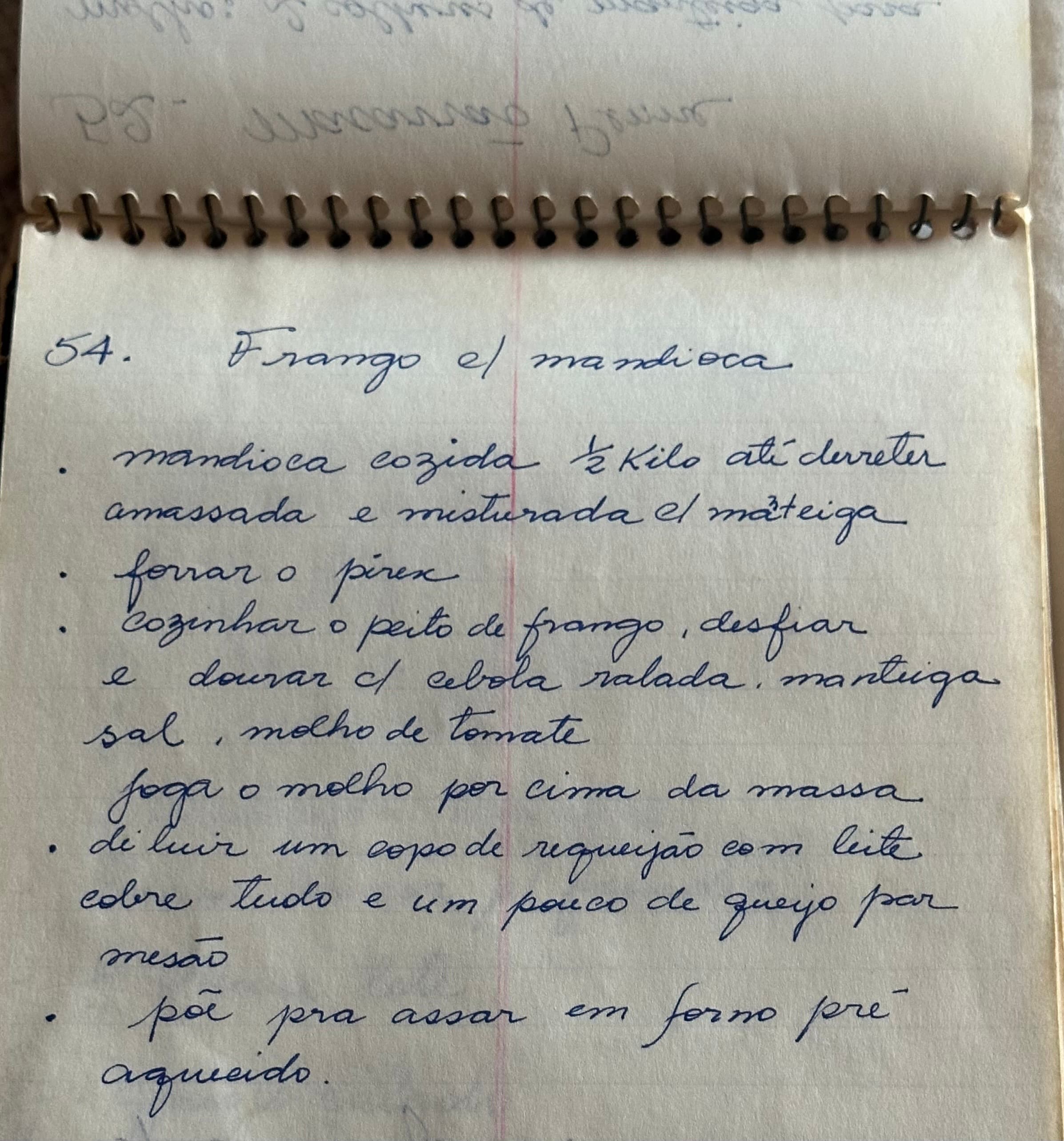 A handwritten recipe for frango com mandioca, in an old spiral notebook
